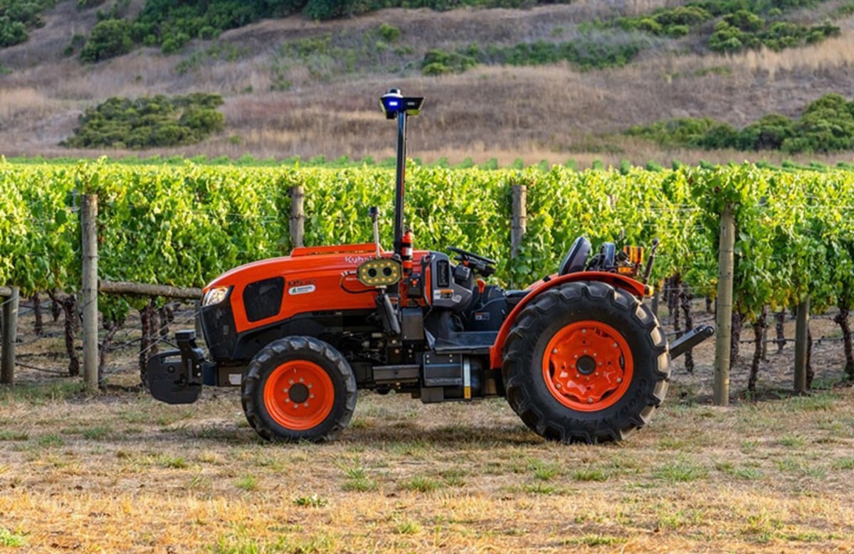 Autonomous Kubota tractor navigating narrow rows in vineyard with AI perception systems