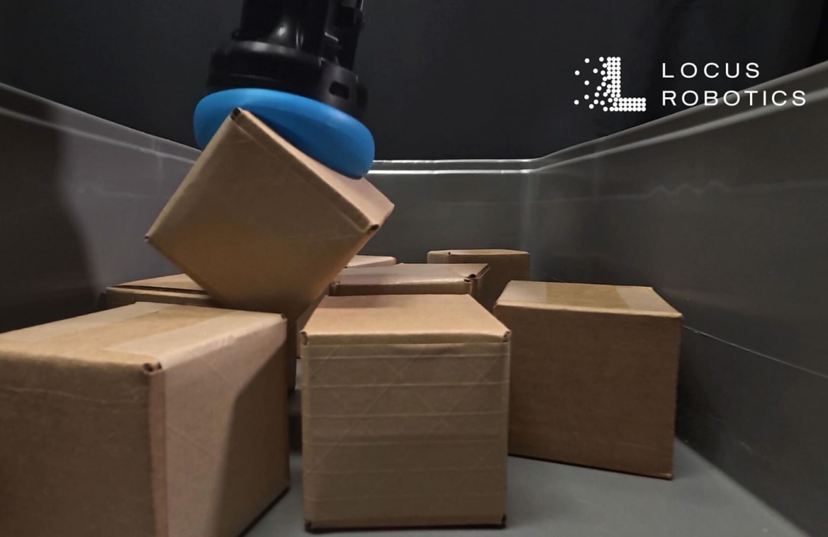 Soft robotic gripper gently grasping a porous plastic bag in warehouse setting