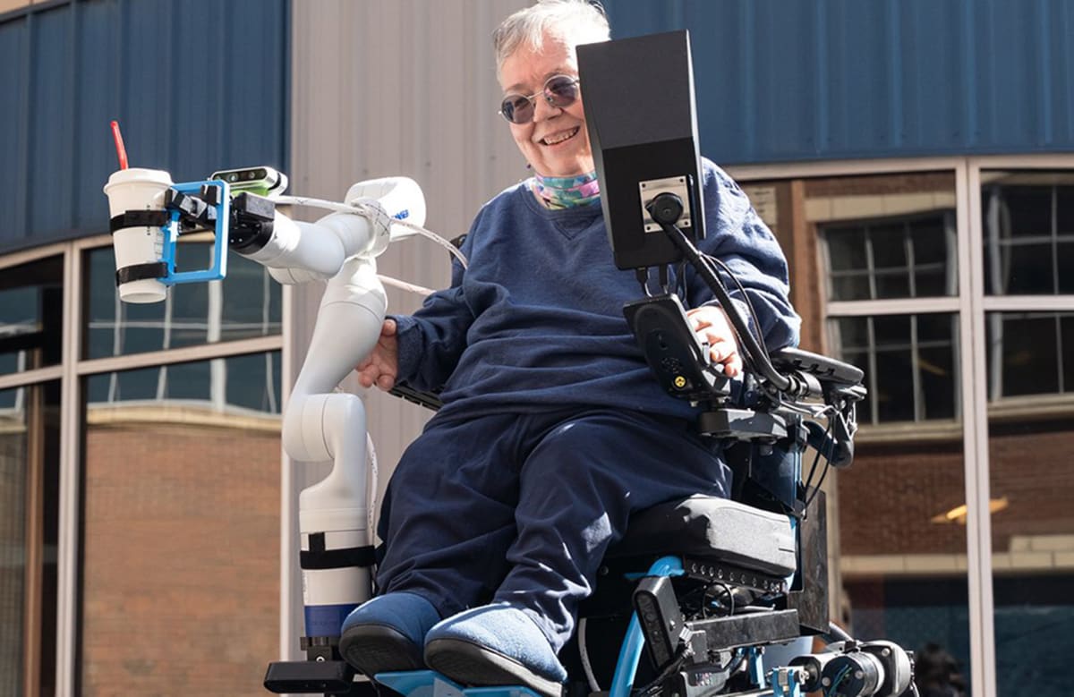 Modern power wheelchair with coordinated robotic arm attached on open software platform