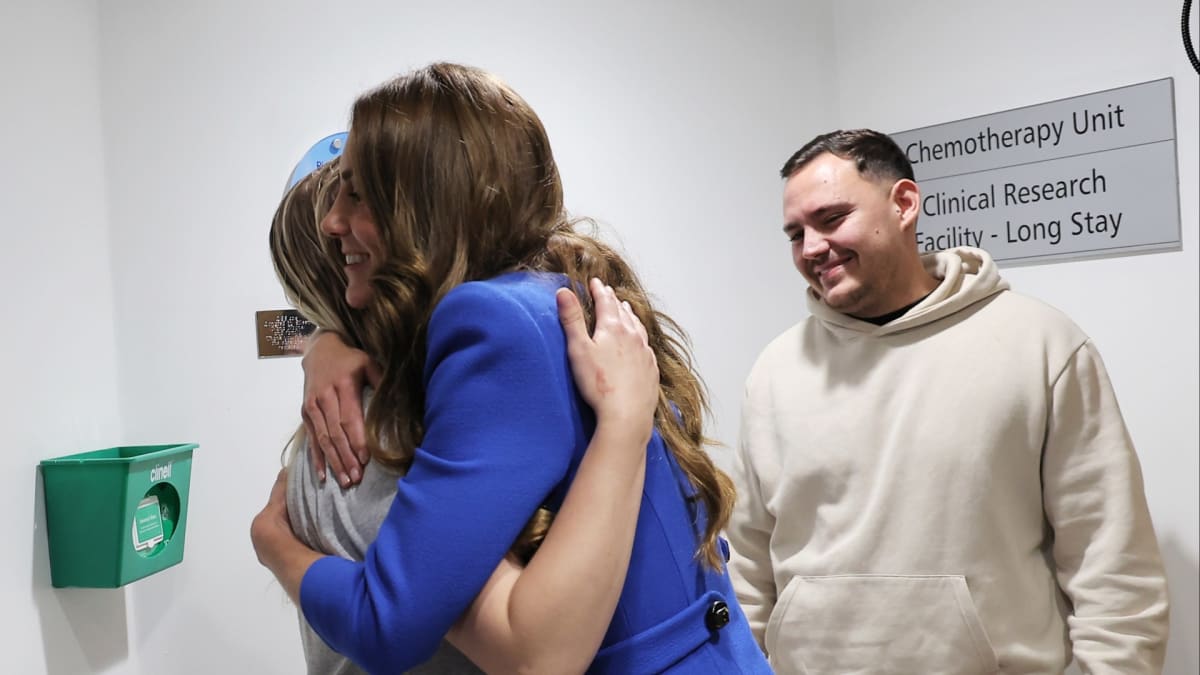 Princess Kate embracing young breast cancer survivor Claire Lorente beside treatment bell