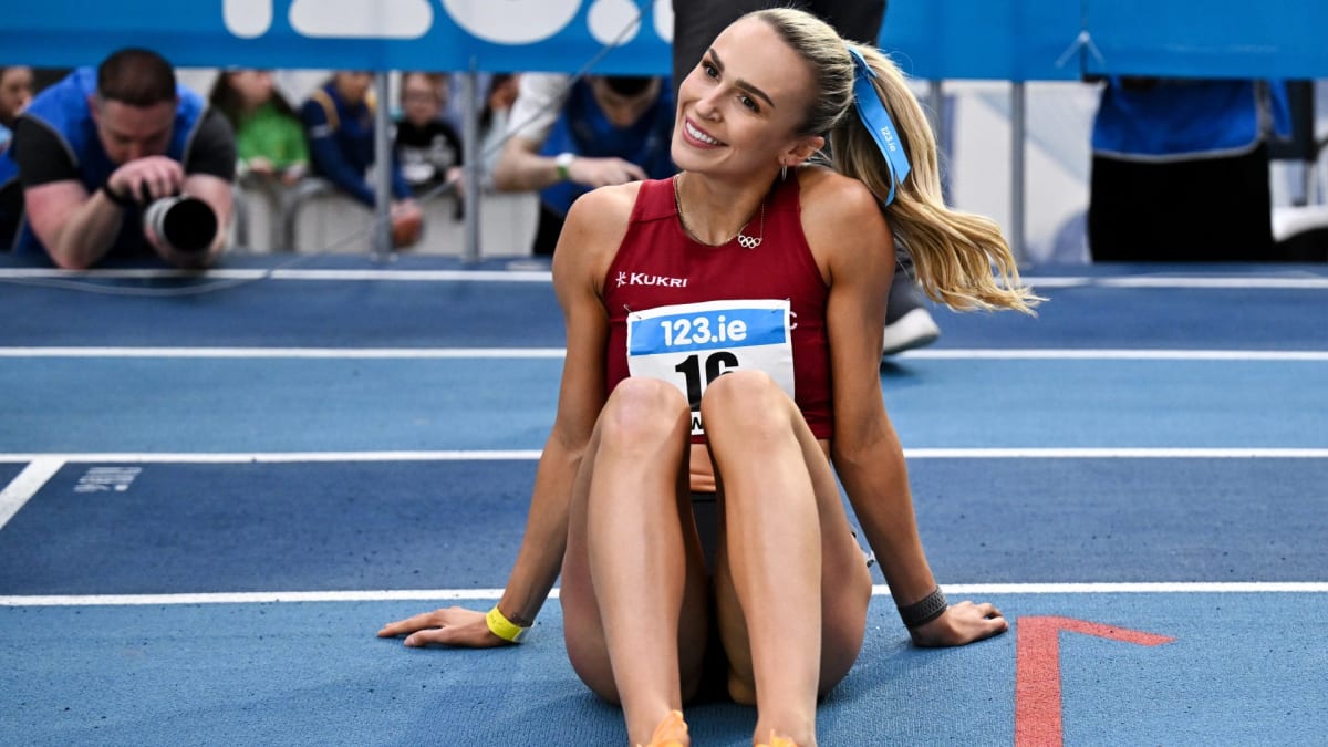 Irish runner Sharlene Mawdsley celebrating on track in racing uniform after breaking personal record
