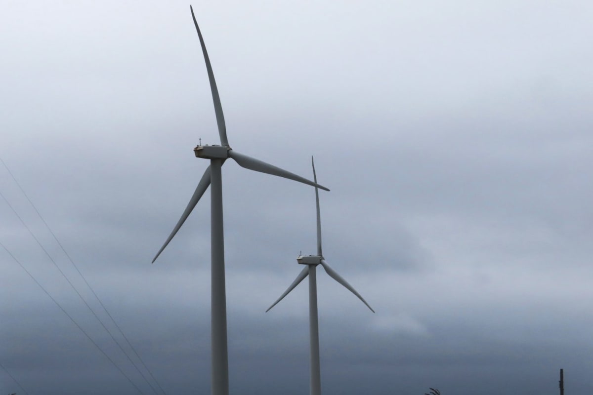 Land-based wind turbines spinning against blue sky in Atlantic City, New Jersey