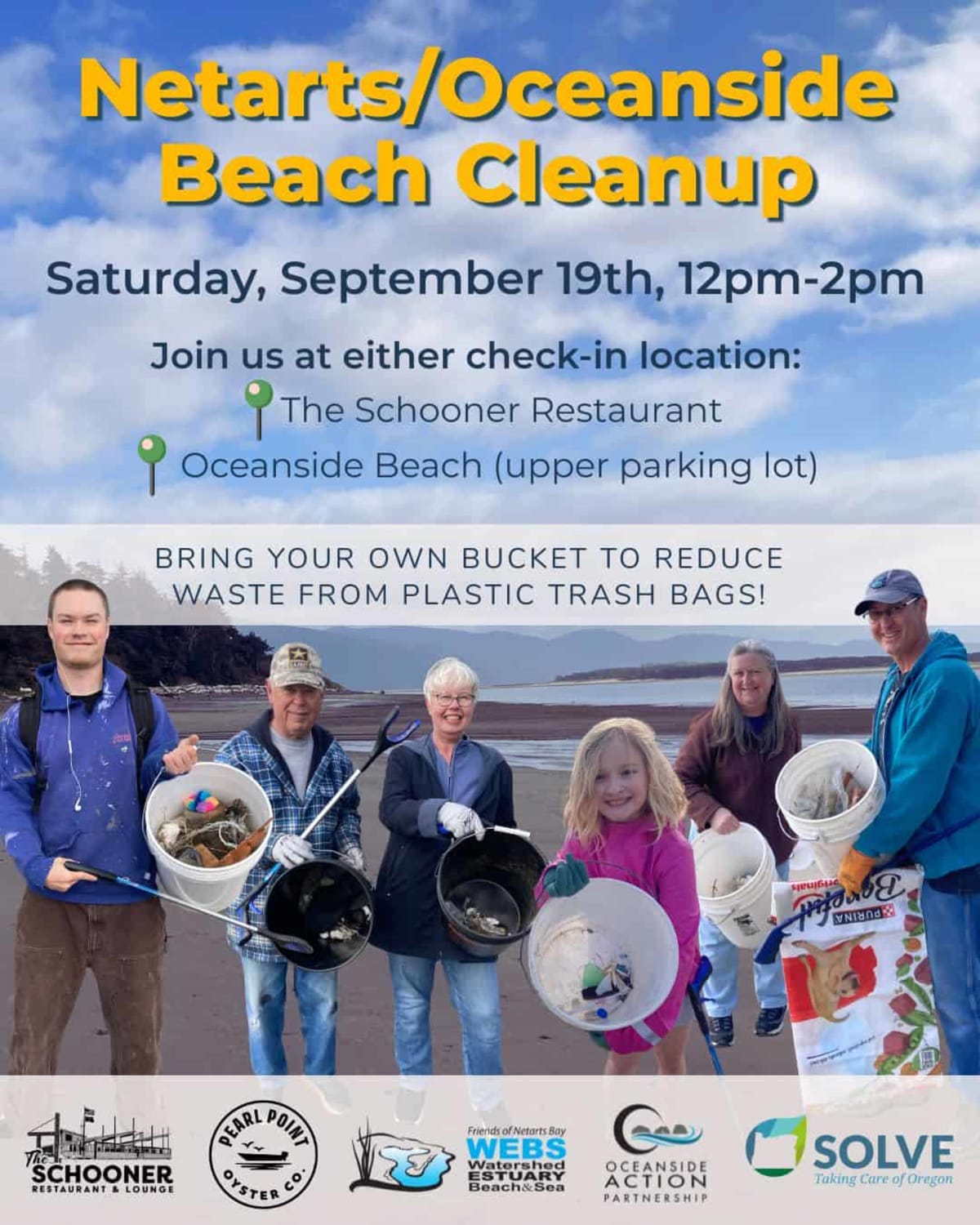 Volunteers with buckets and gloves cleaning up sandy Oregon beach near rocky coastline