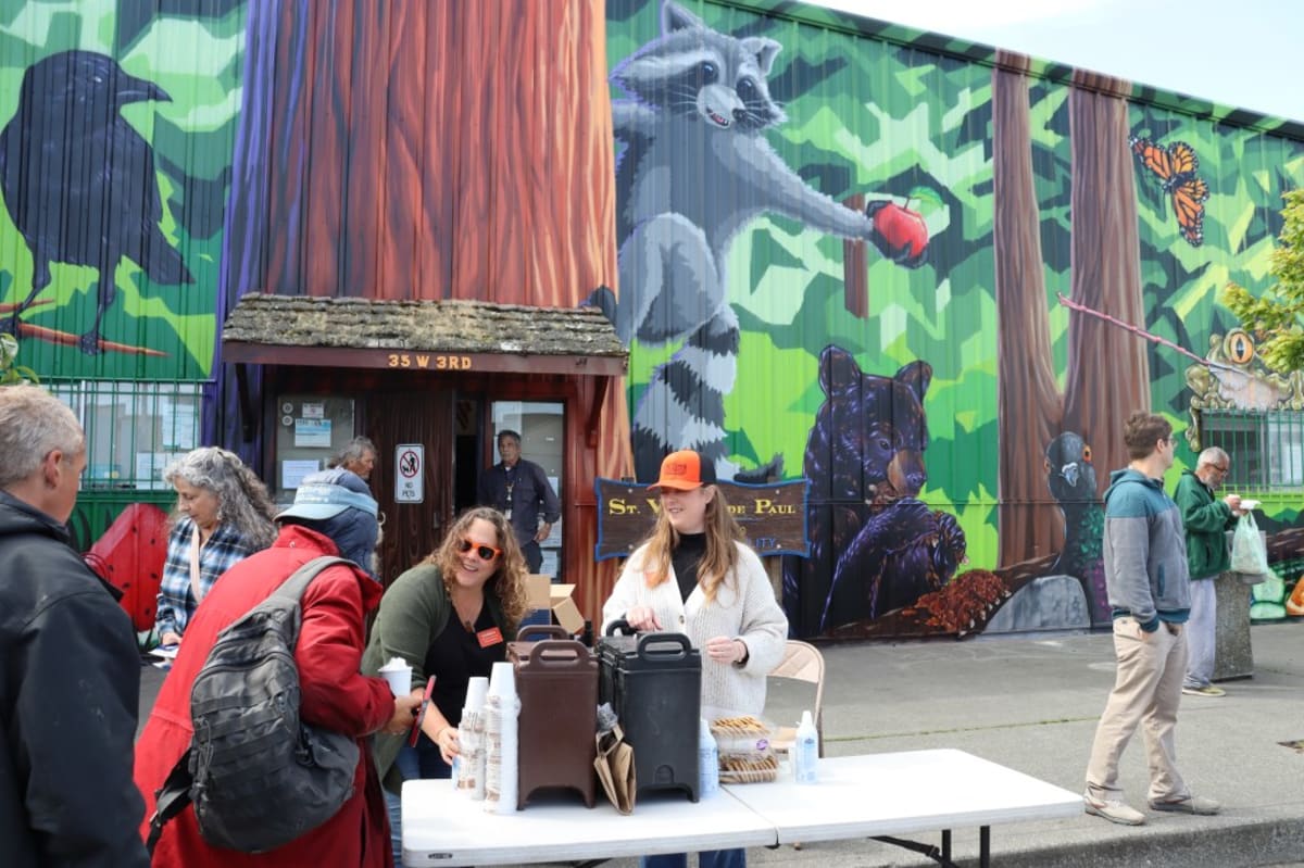 ** Volunteers serving hot chocolate to community members at Unity Day celebration in Eureka
