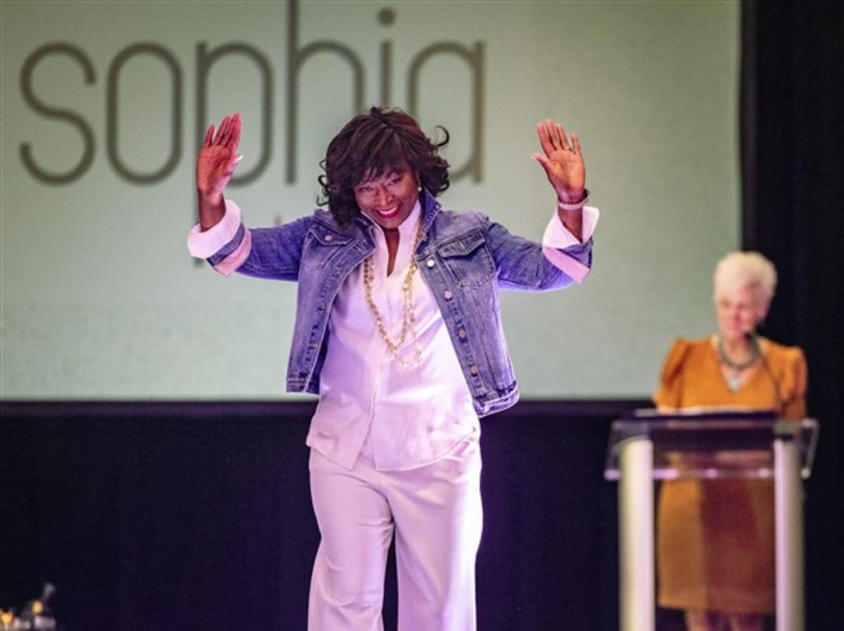 Cancer survivors modeling spring fashions on runway at Victory Center charity event in Toledo