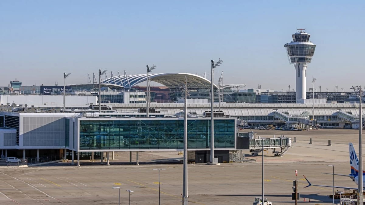 Modern Munich Airport terminal with solar panels and electric vehicles on tarmac