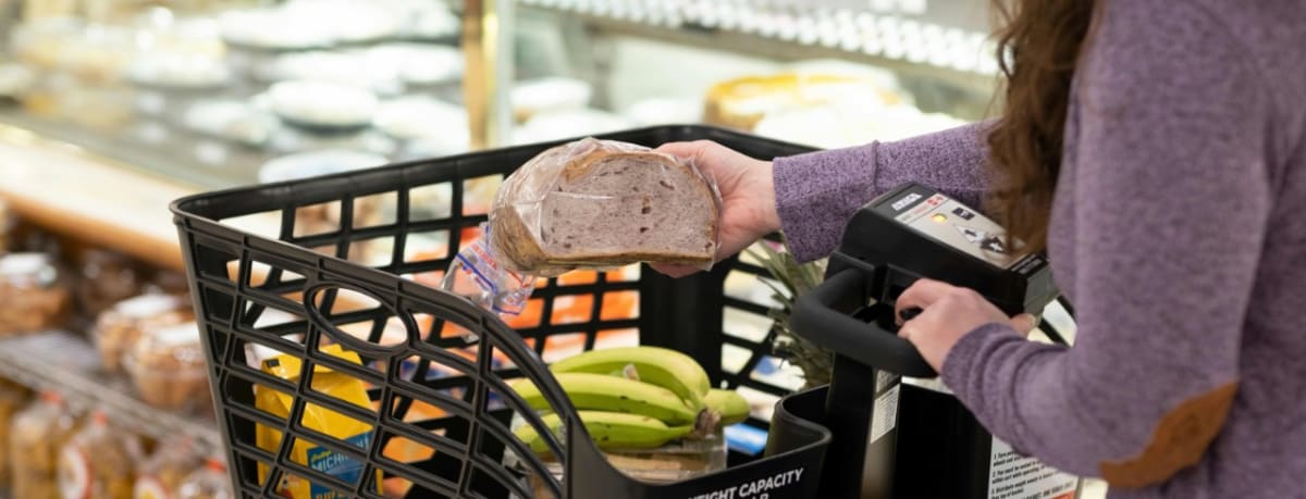 Compact grocery fulfillment robots working in refrigerated storage inside retail store back room