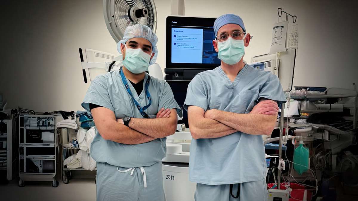 Two UCLA Health doctors in medical attire standing together discussing precision lung cancer treatment approach
