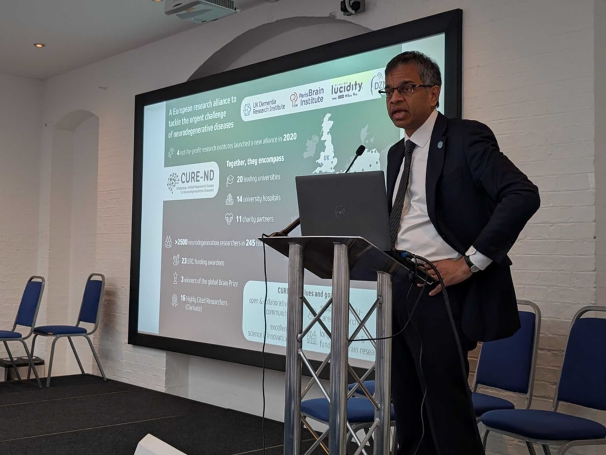 Scientists collaborating at research facility working on neurodegenerative disease treatments in modern European laboratory