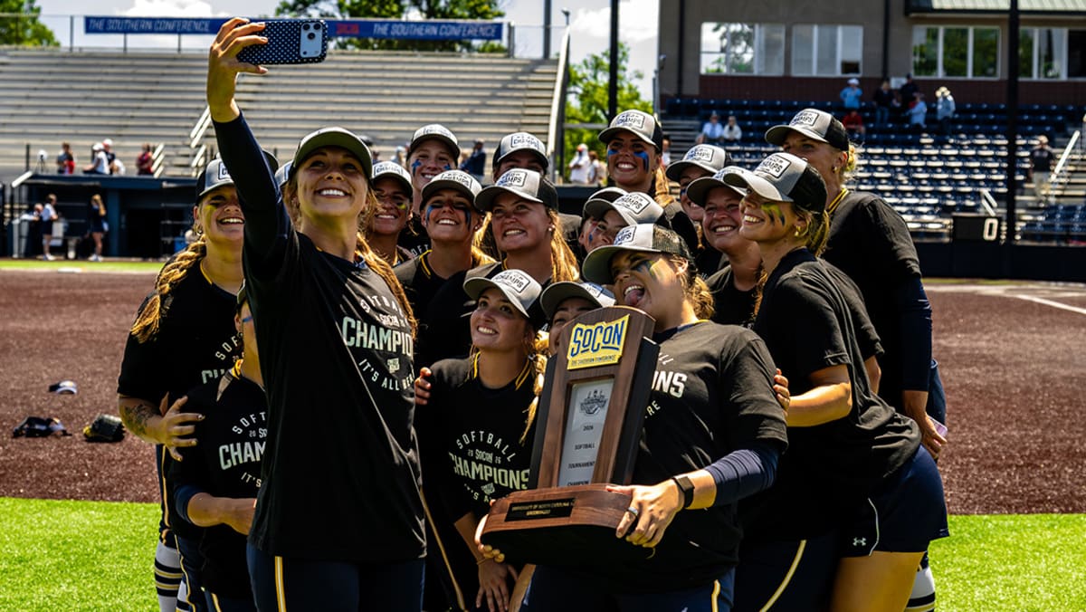 UNCG softball team celebrating their Southern Conference Championship victory on field in Chattanooga
