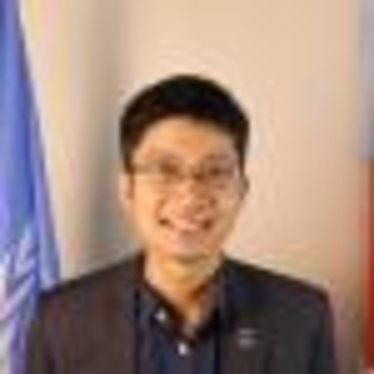 Young Thai students collaborating at tables with policy documents and sticky notes during participatory workshop