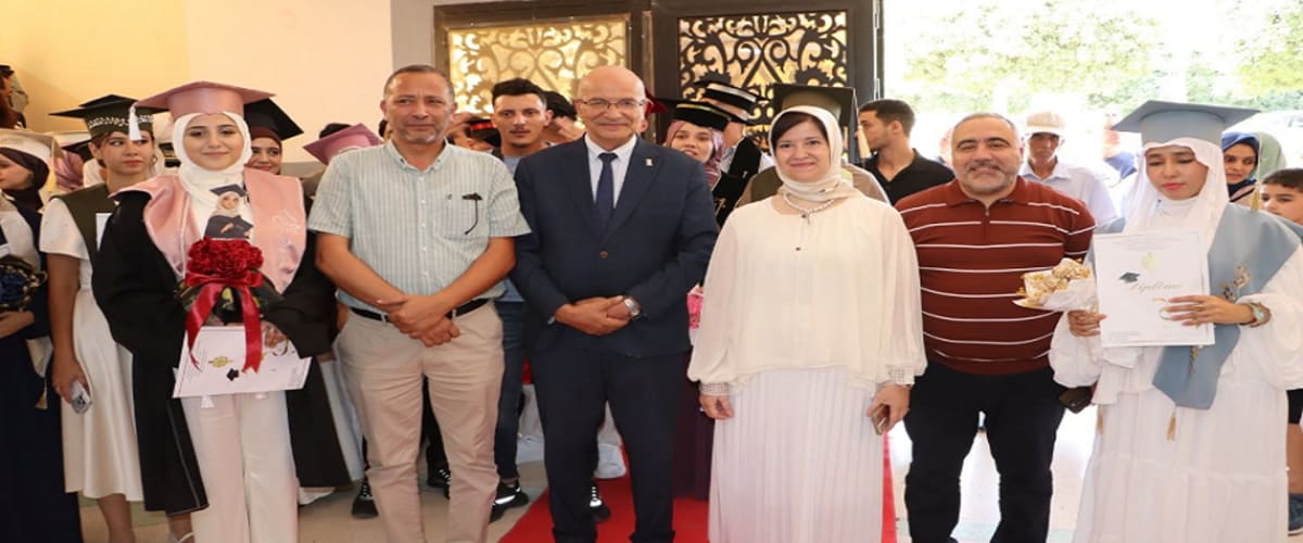 University graduates in caps and gowns celebrating with families at Tlemcen University ceremony