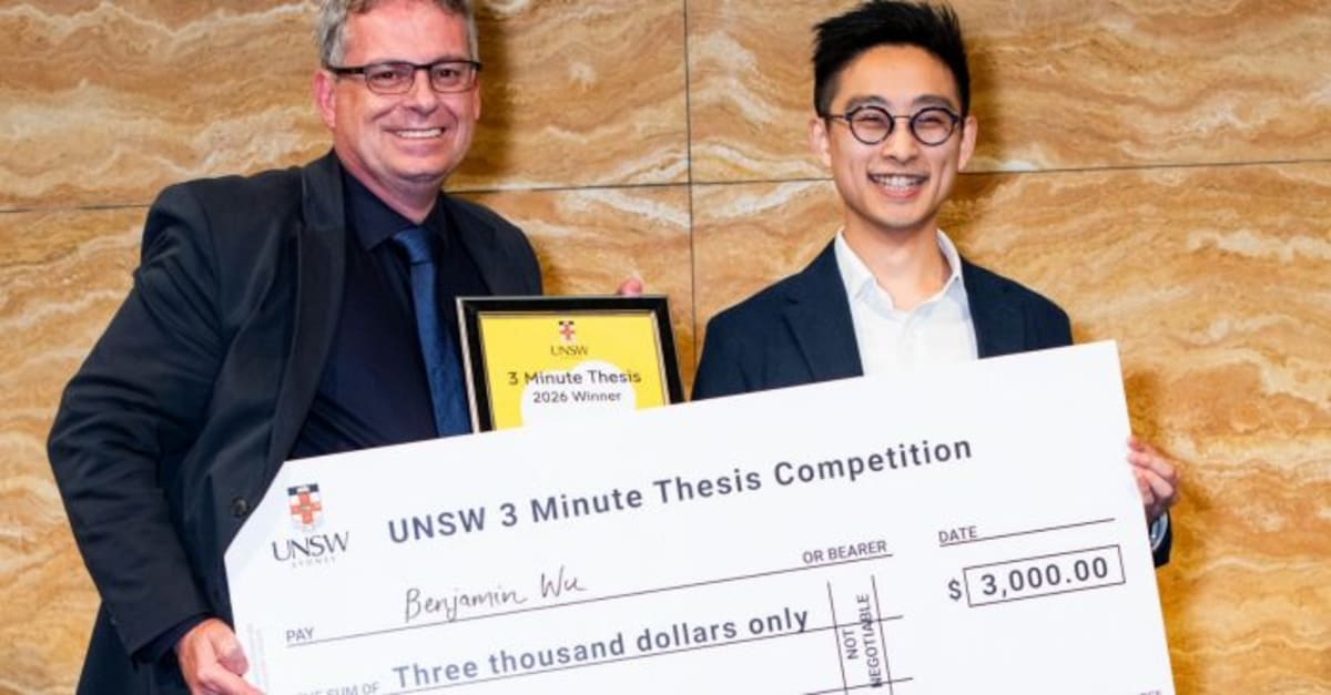 PhD researcher Benjamin Wu holding award after winning UNSW's 3 Minute Thesis competition for fertility research