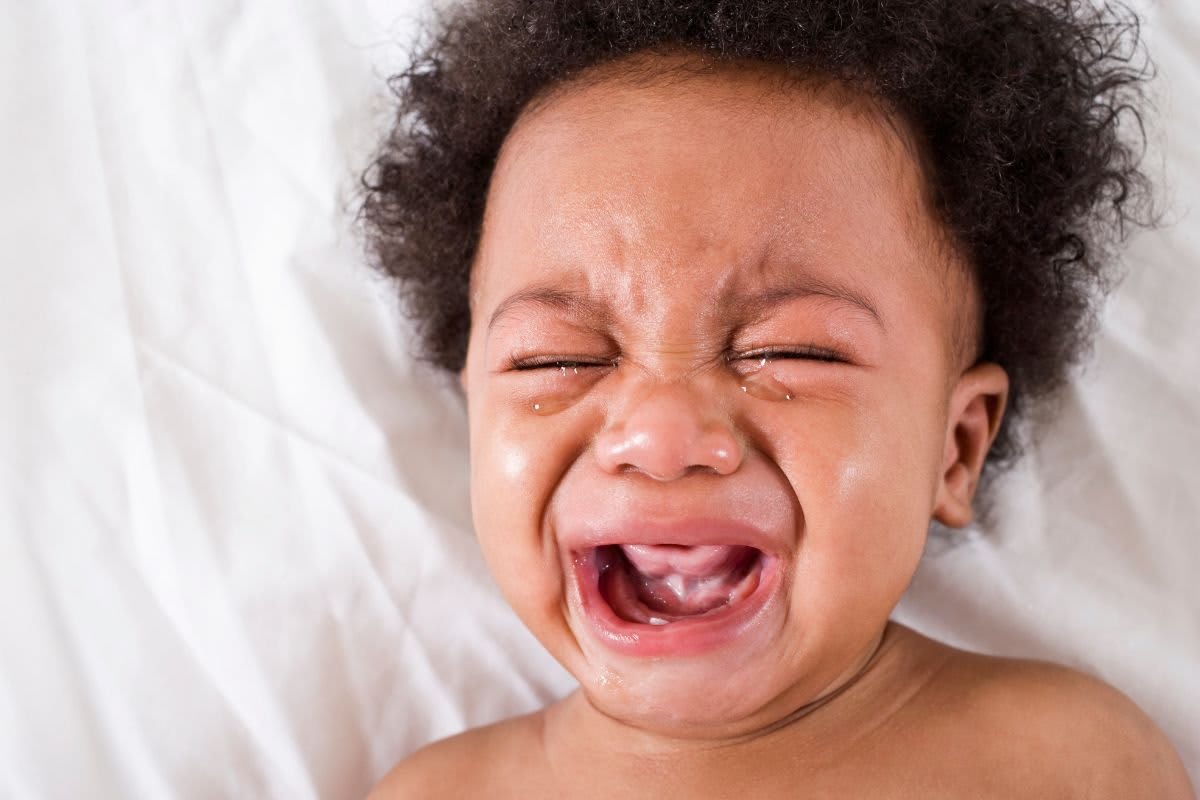 Baby monitor footage showing young boy in crib comforting toddler brother at night
