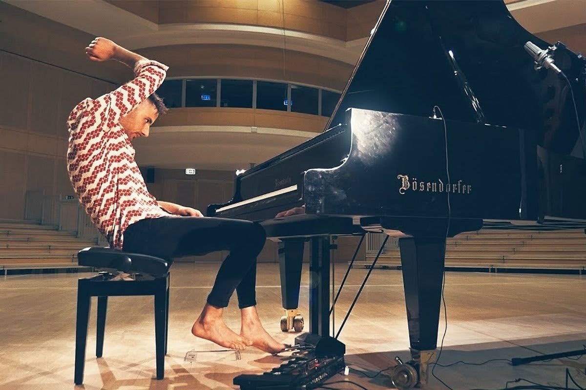 Hungarian pianist Peter Bence playing piano barefoot during creative viral performance