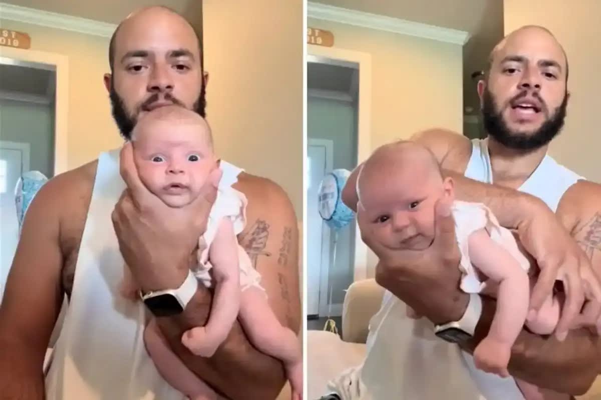 Father holding newborn baby daughter while filming TikTok video parody of Amazon product review