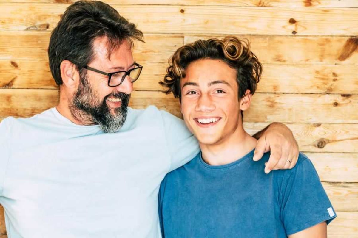 Orthopedic surgeon Dr. James Wittig with adopted son Ronnie smiling together