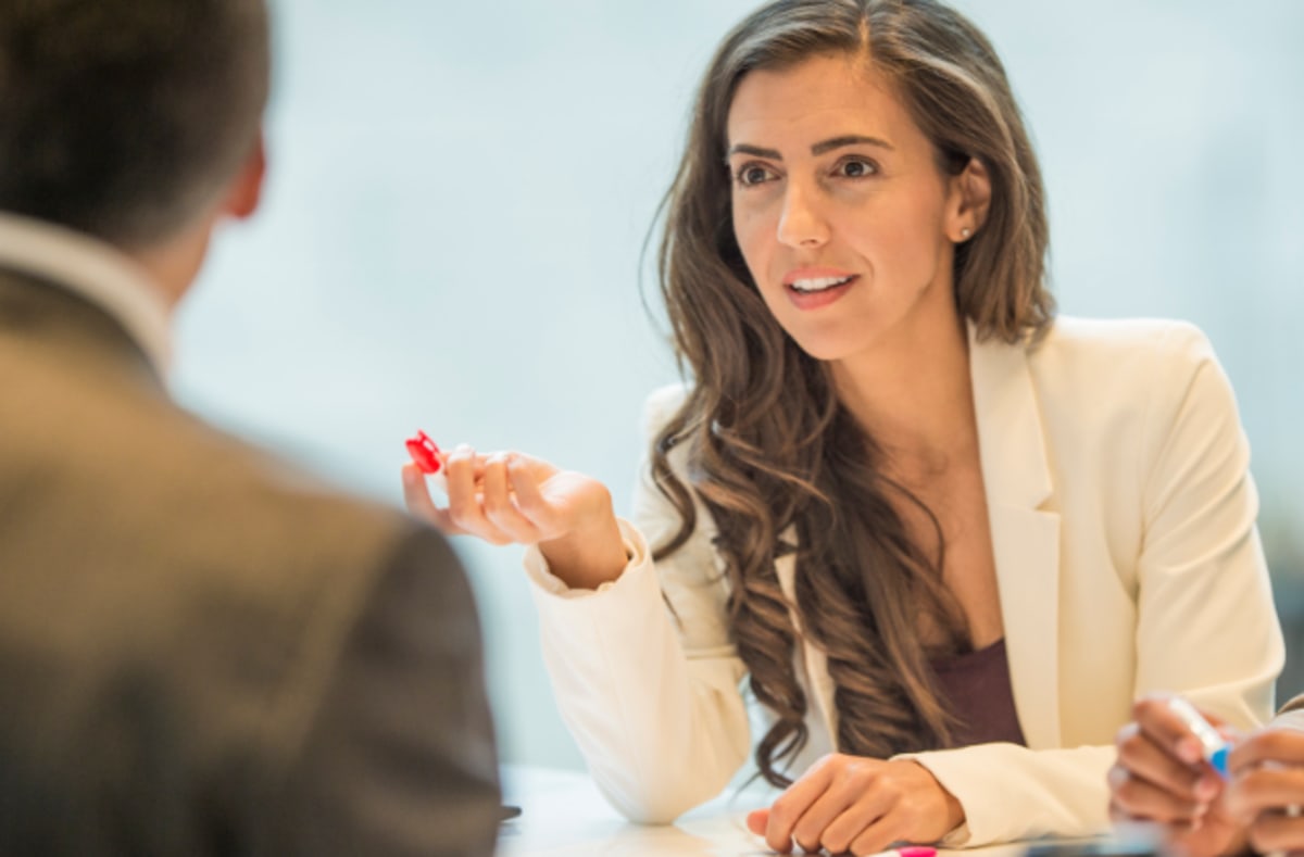 Two people having a calm, productive conversation while sitting together in natural light