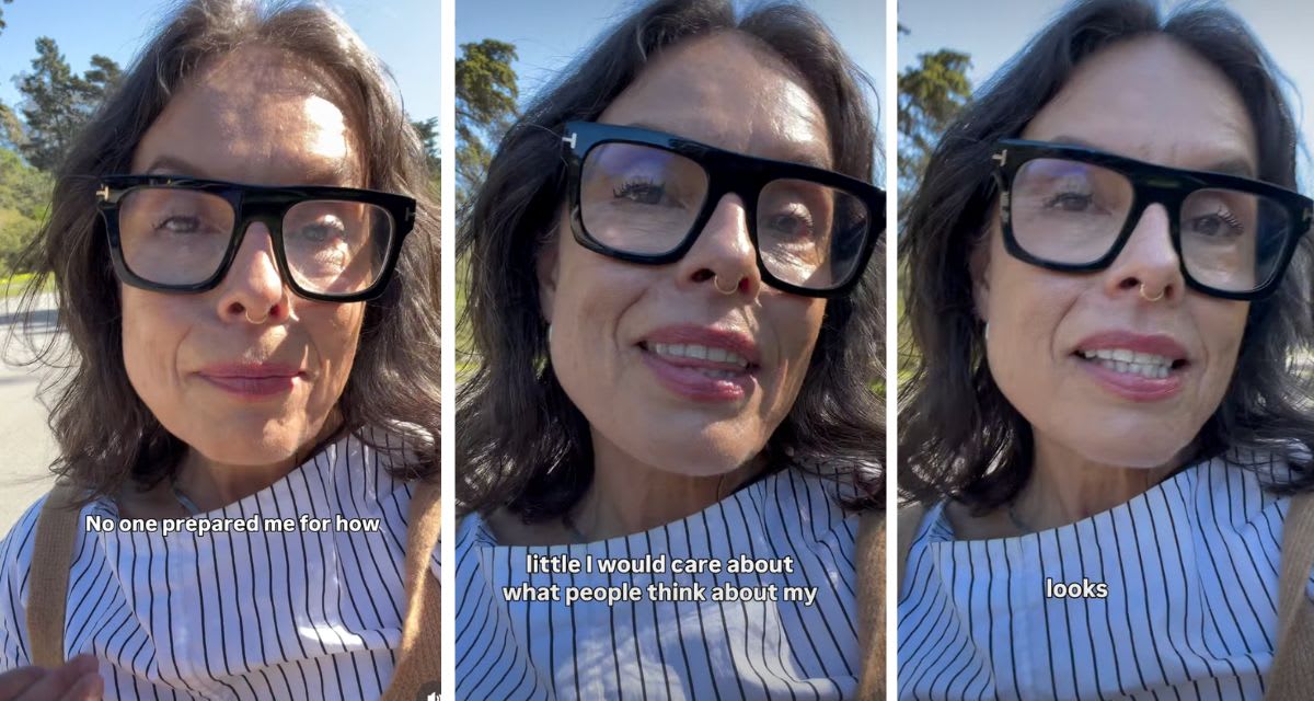 ** Confident woman in her 40s smiling naturally with gray hair and visible wrinkles