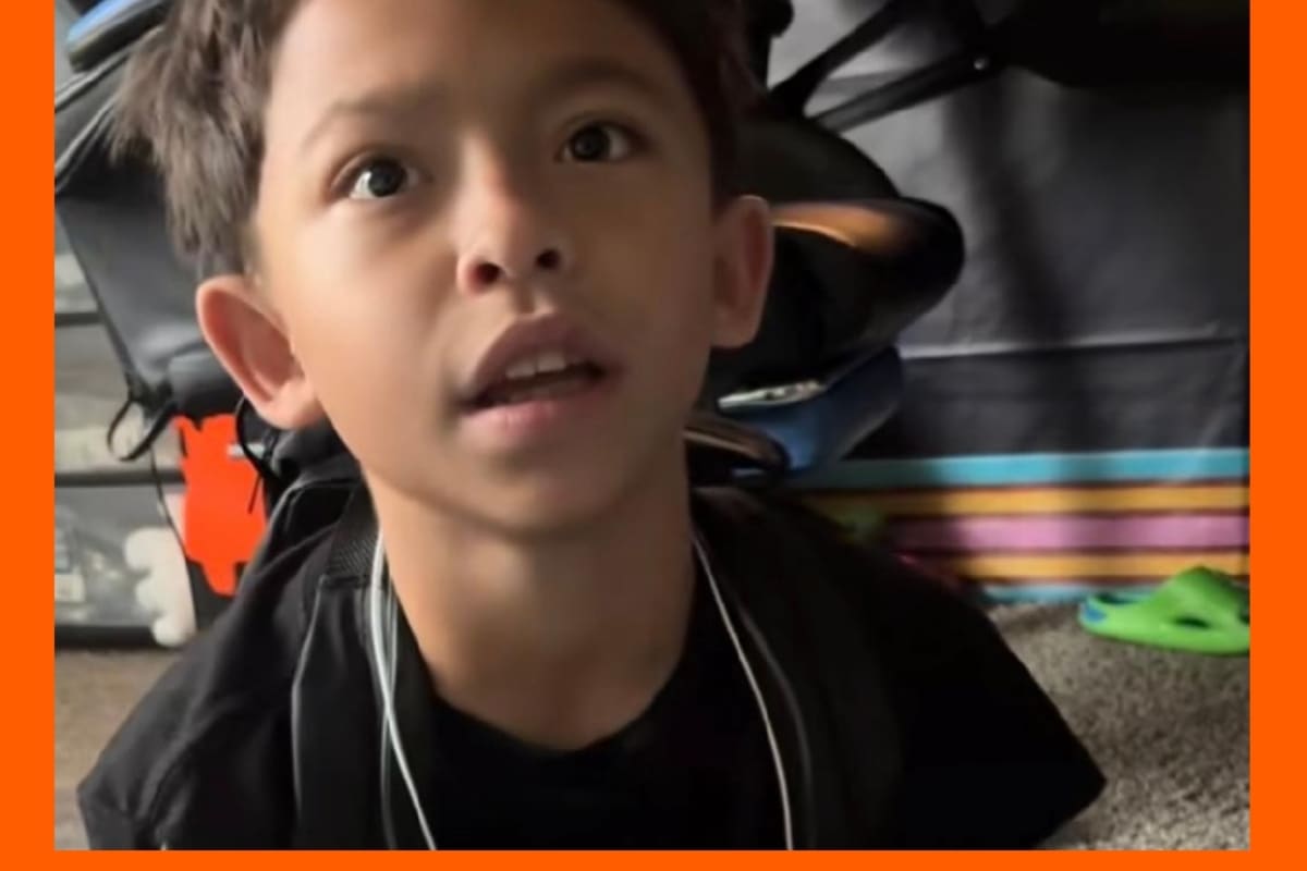 Young teen boy Josue Carrizosa sitting on floor talking to his father about helping classmate