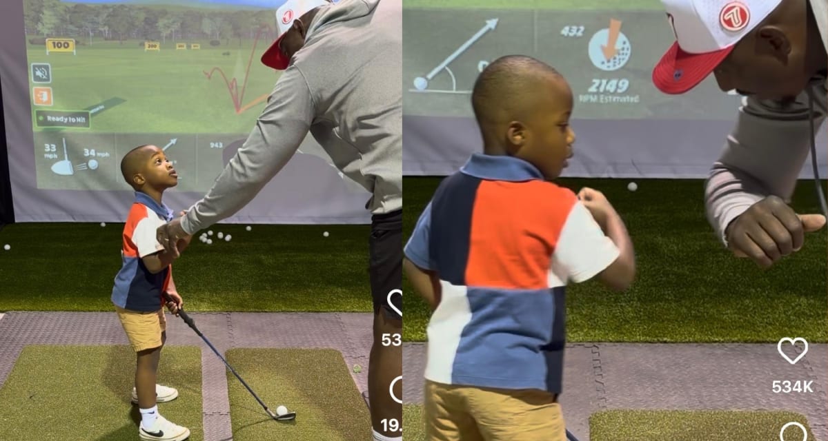 Father and young son practicing golf together on indoor simulator screen