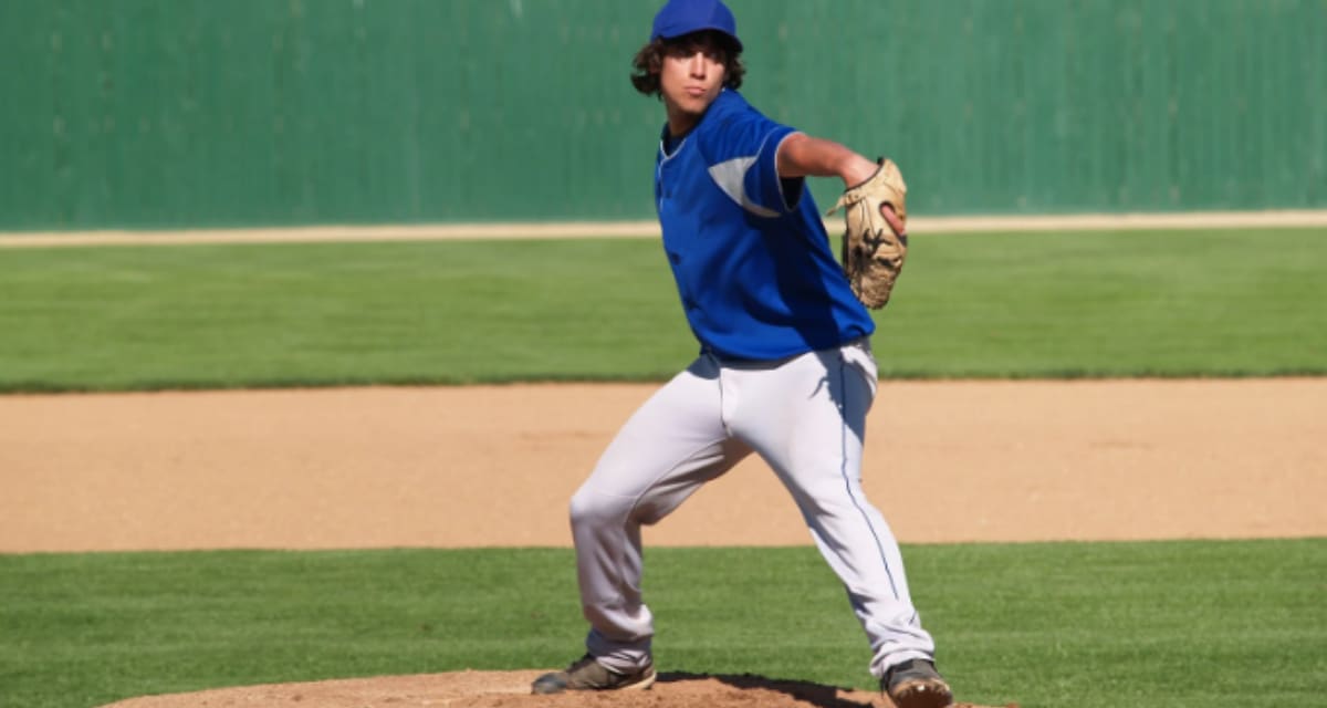 High school baseball pitcher Chris McNeal in uniform on the mound with prosthetic leg