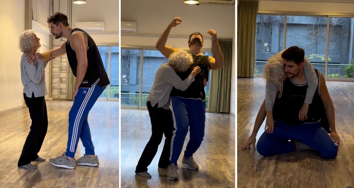 Older woman and young male choreographer dancing together in empty studio space
