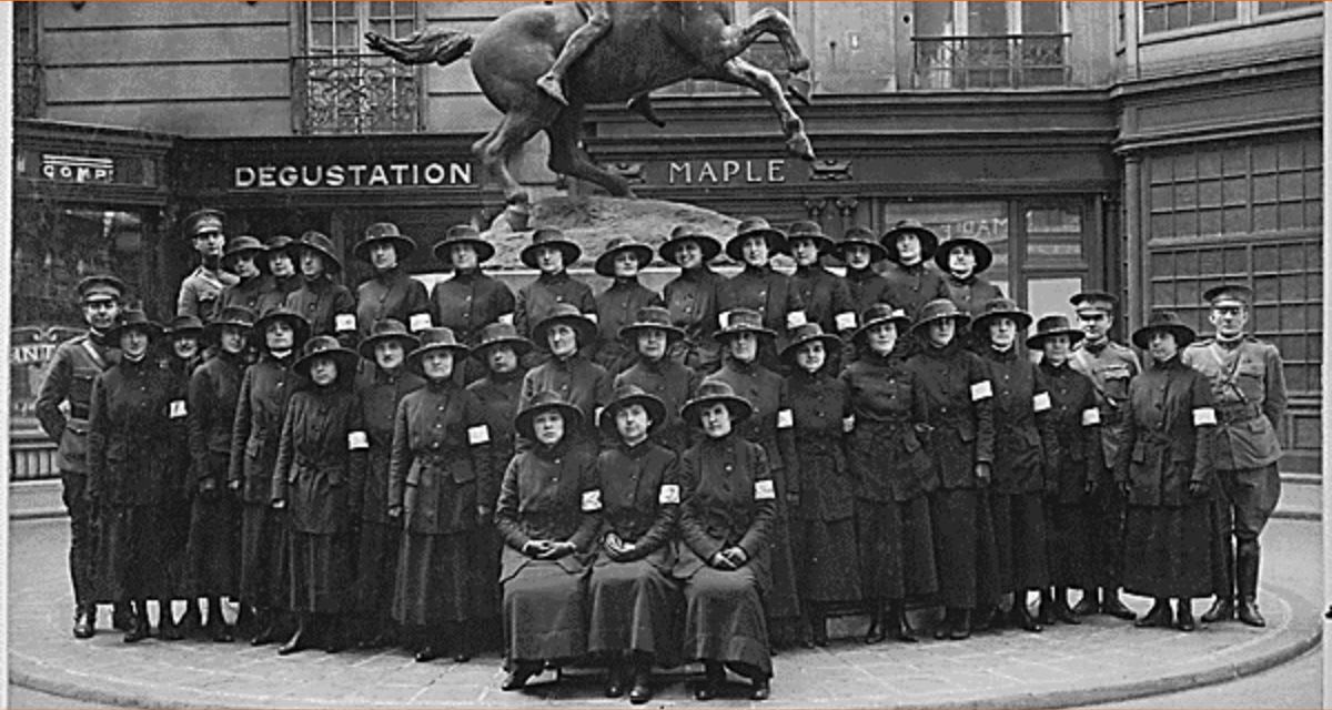WWI-era female telephone switchboard operators in military uniforms at their stations in France