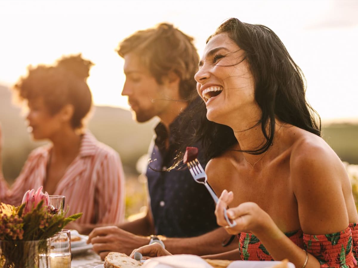 Diverse group of friends laughing together at outdoor community festival celebration