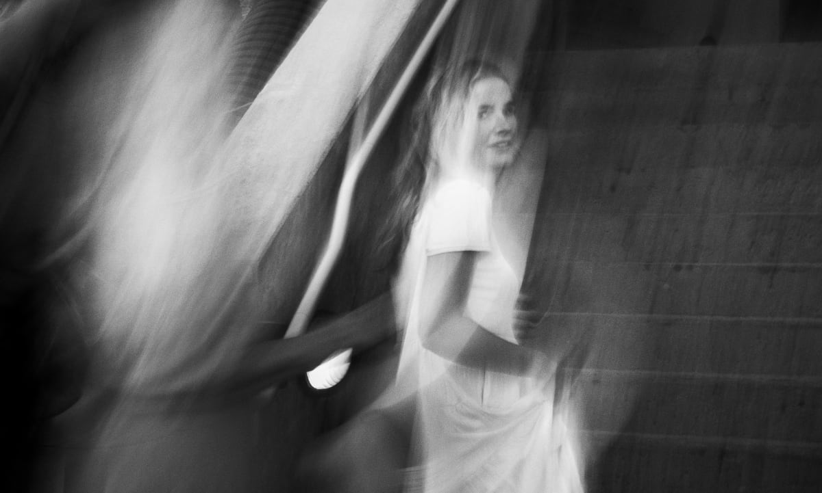Double exposed photograph showing bride walking down aisle with ghosted image of father beside her