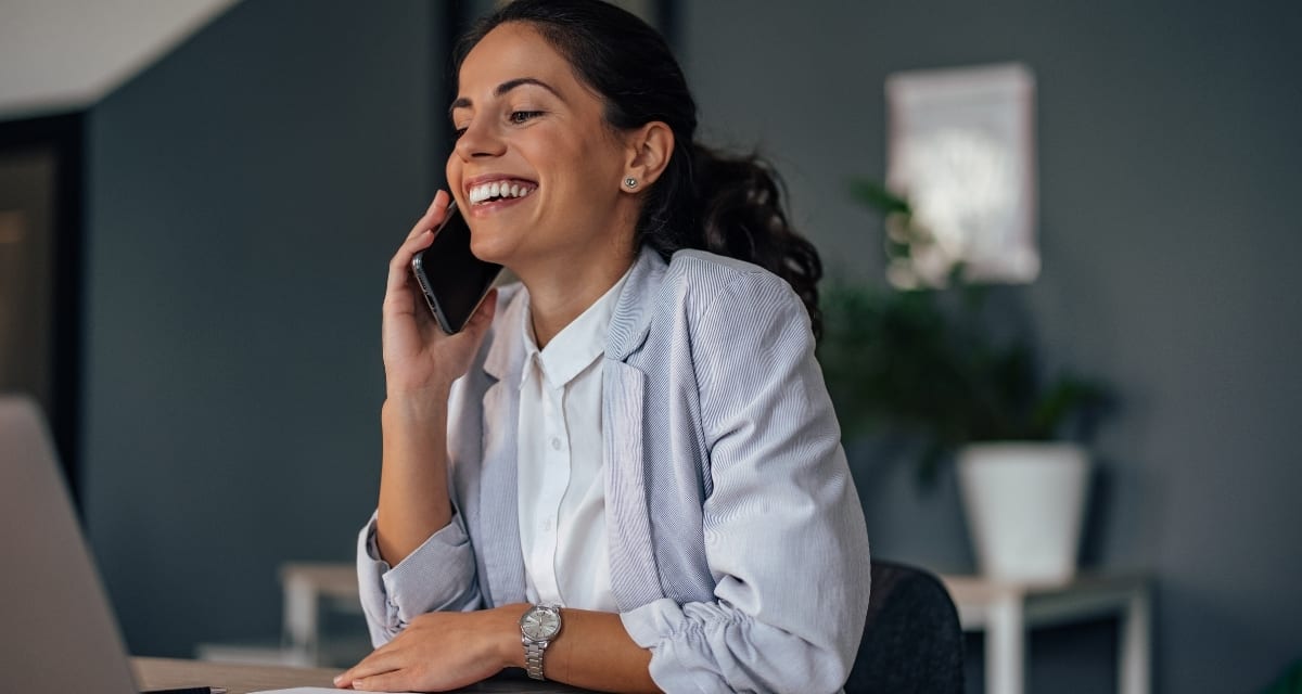 Young woman sitting at computer desk on her last day of work