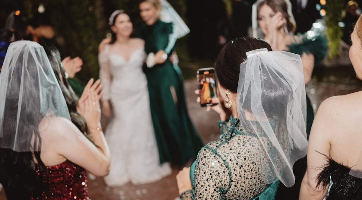 Woman celebrating with friends at outdoor venue in Tuscany Italy