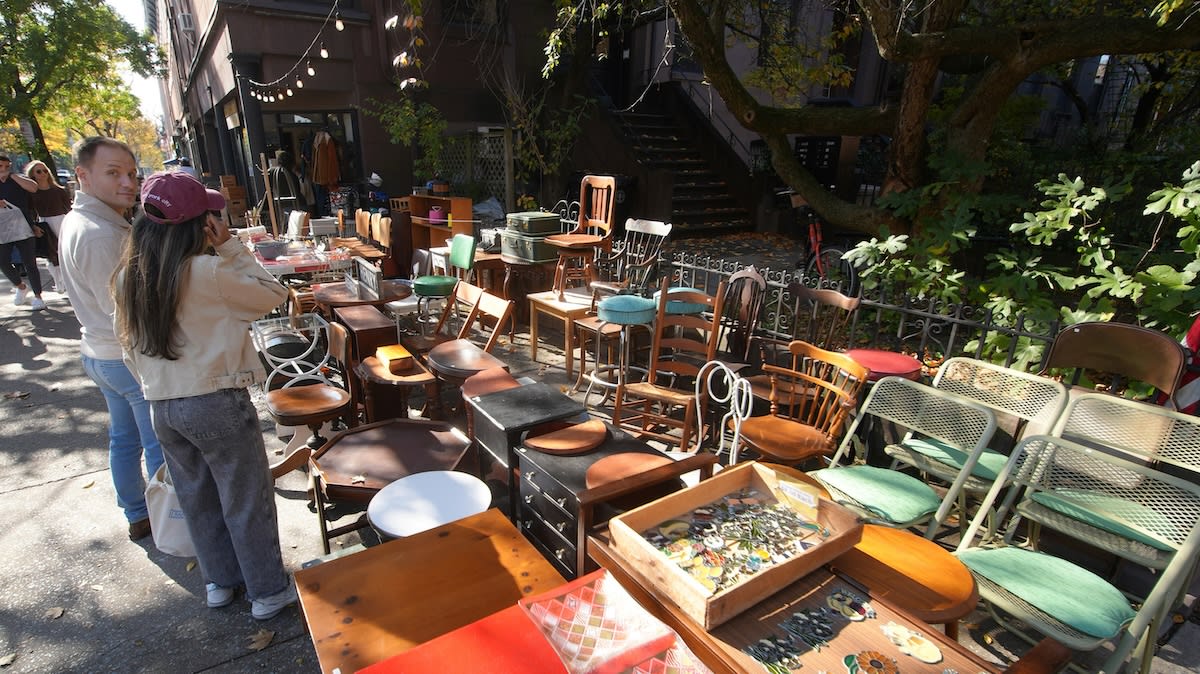 Collection of vintage family photos and memorabilia laid out at a yard sale display