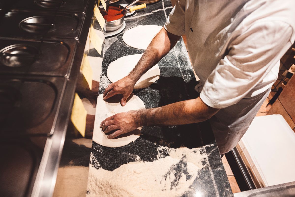 Jacob Bartoli making pizza at Papa John's while speaking to camera about workplace respect