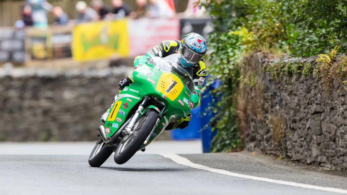 ** John McGuinness racing motorcycle on Isle of Man Mountain Course during Classic TT victory