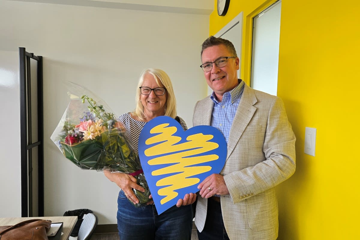 Marian Best smiling at Porchlight Counselling office in Cambridge Ontario receiving community recognition award