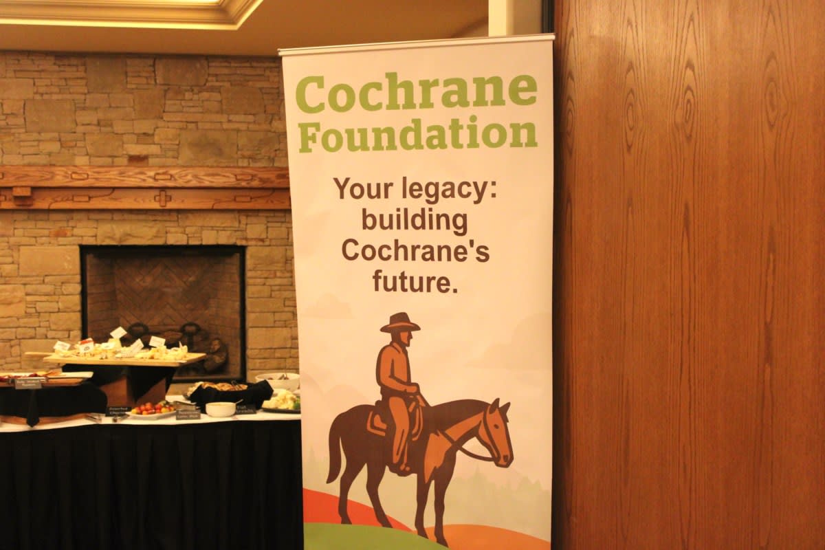 Tim Harvie presenting oversized ceremonial check to smiling nonprofit representatives at granting ceremony