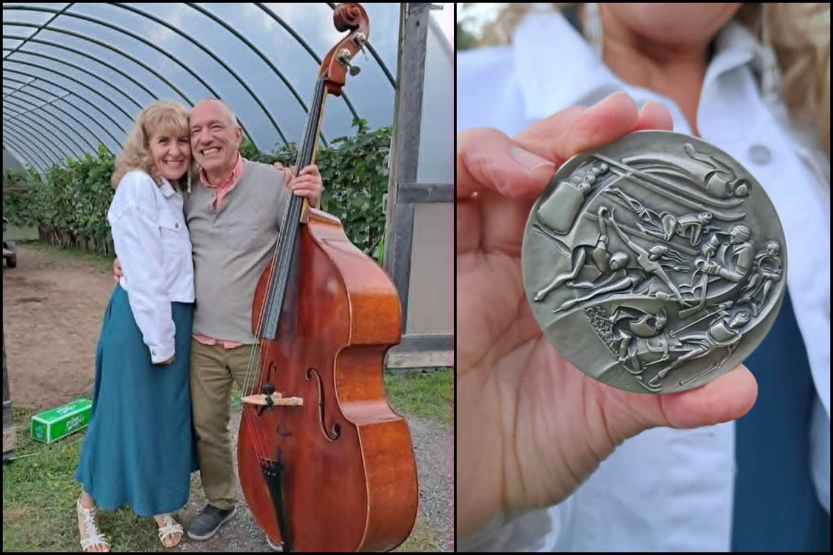 Four-time Olympic cross-country skier Angela Schmidt Foster holding her replacement 1980 Lake Placid participation medal