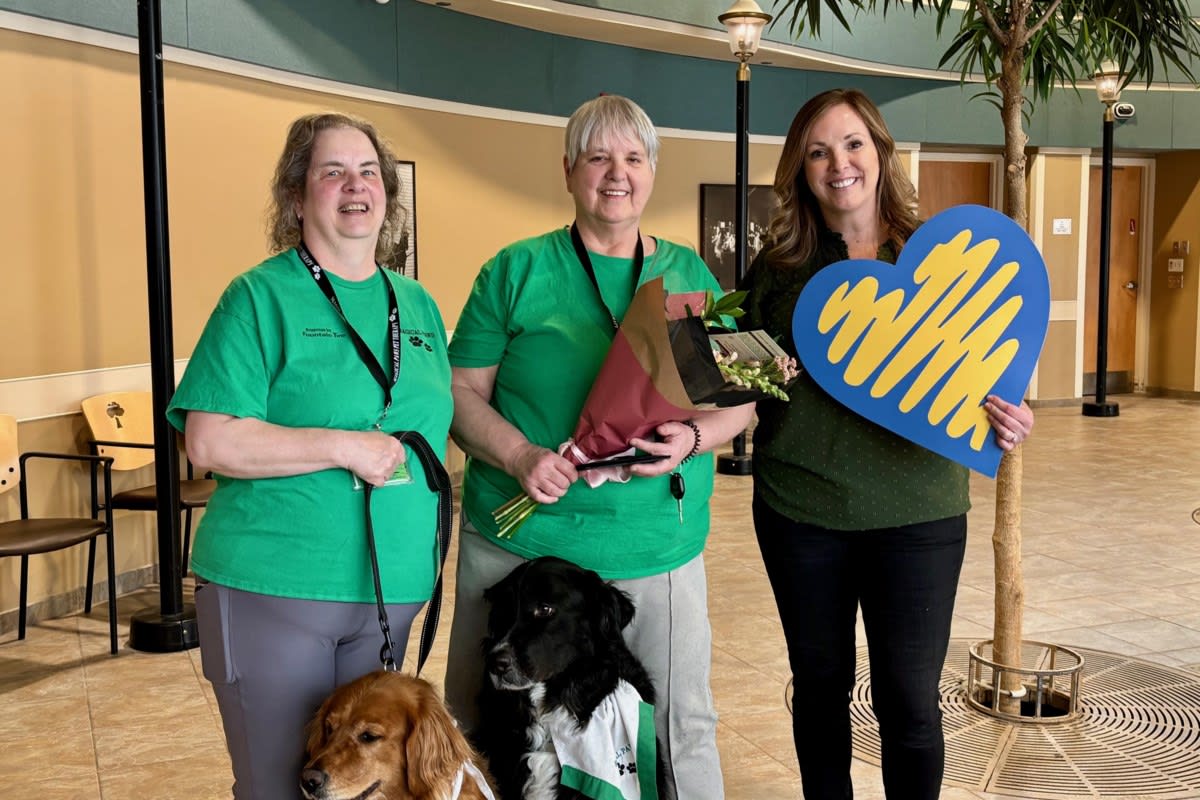 Therapy dog visiting elderly nursing home resident bringing joy and comfort through animal-assisted care