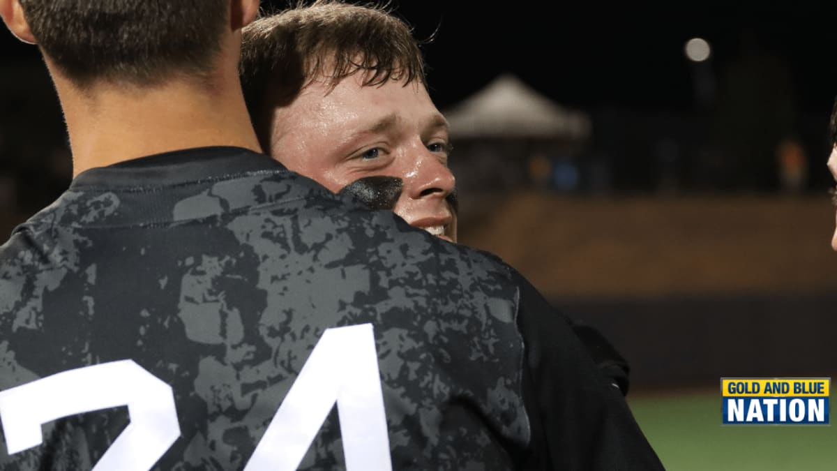 West Virginia baseball players celebrating on field after walk-off championship victory