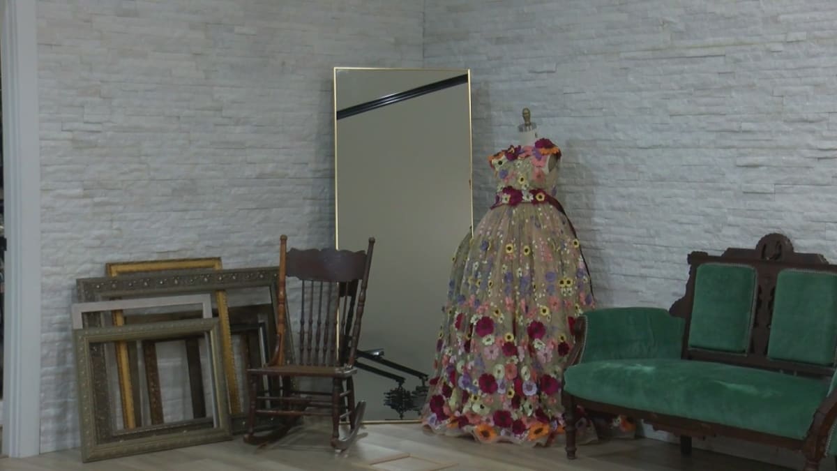 Emily Donohoe working on colorful canvas artwork in her Mahomet photography studio