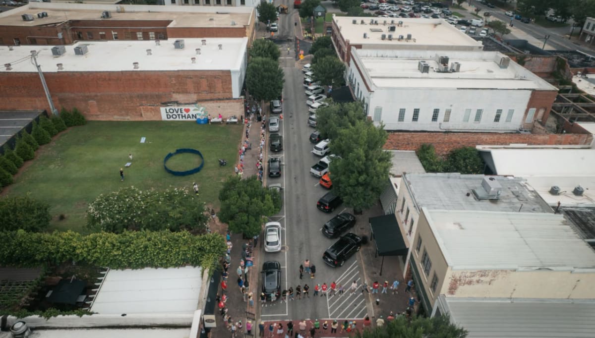Volunteers forming a human chain on street passing books hand to hand in Dothan Alabama