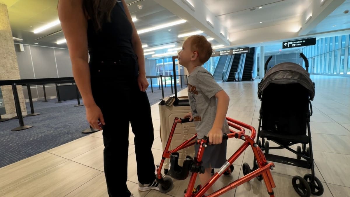 Seven-year-old Mikey Hartnett smiling, a brain cancer survivor advocating for children's healthcare access