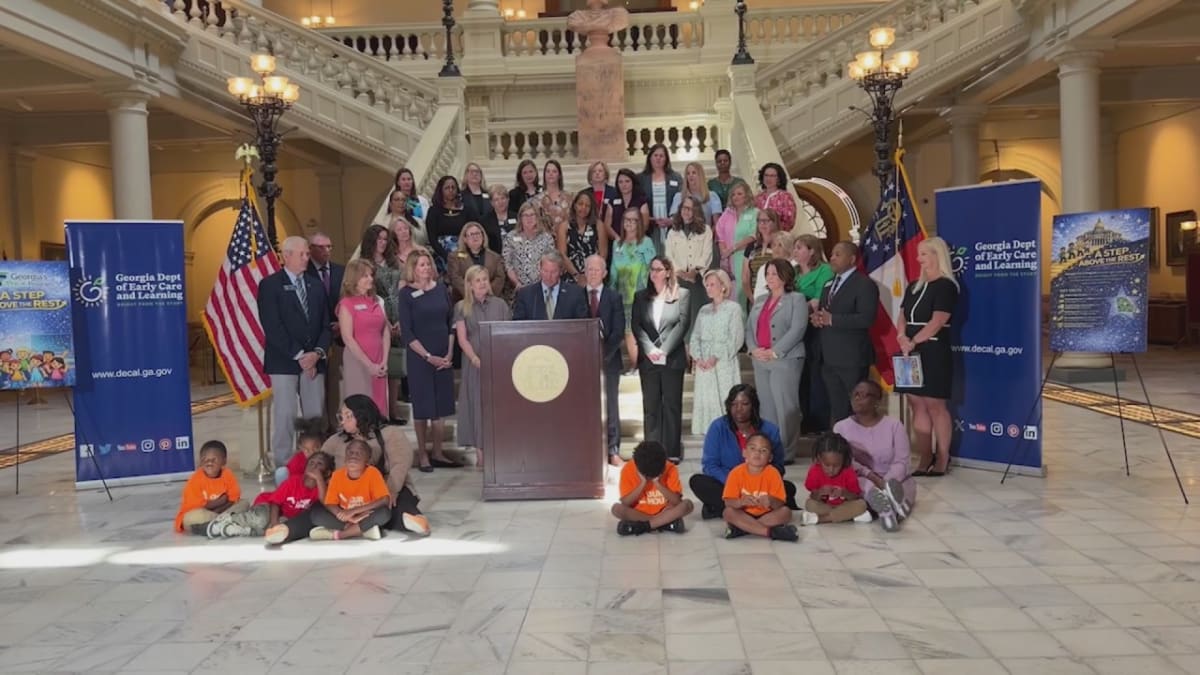 Preschool children learning together in a Georgia Pre-K classroom with teacher assistance