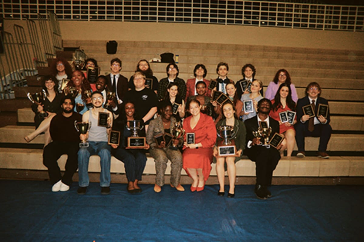 Western Kentucky University forensics team members posing together after winning national debate championship