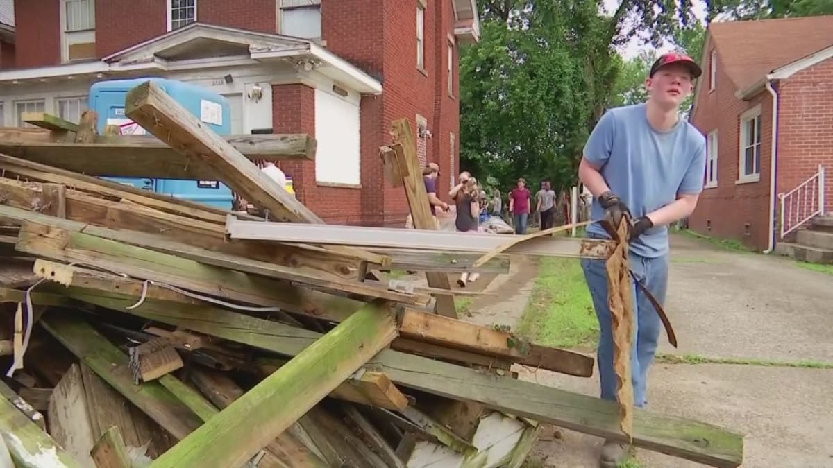 Young volunteers in work clothes painting and repairing homes in Huntington West Virginia community