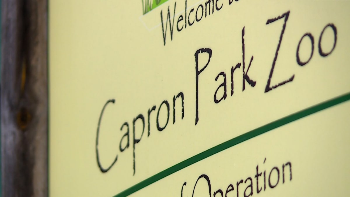Capron Park Zoo entrance sign with trees and pathways in Attleboro, Massachusetts