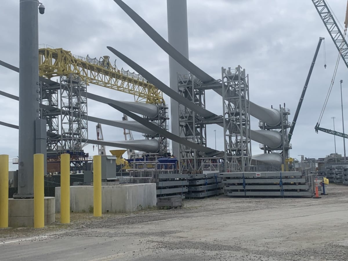 Offshore wind turbines spinning above ocean waters generating clean electricity for New England