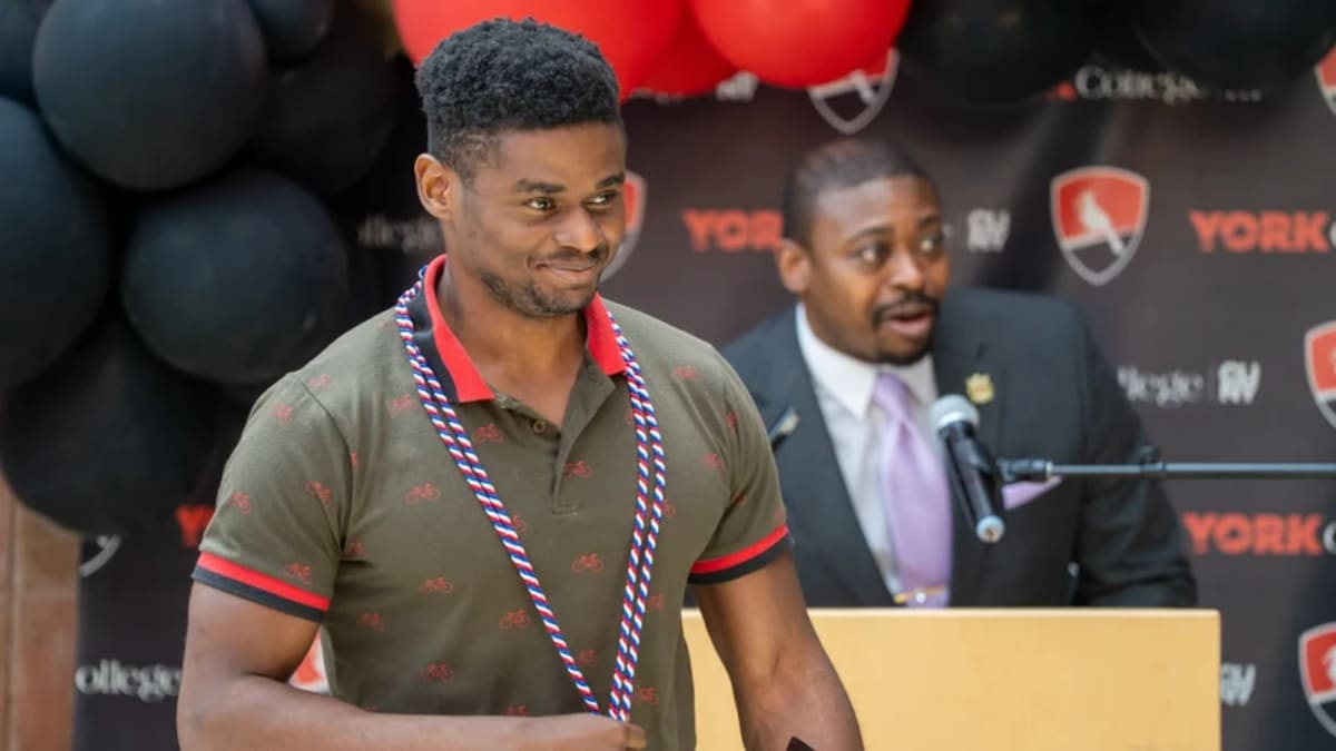 Graduates in caps and gowns celebrating with families at York College luncheon event