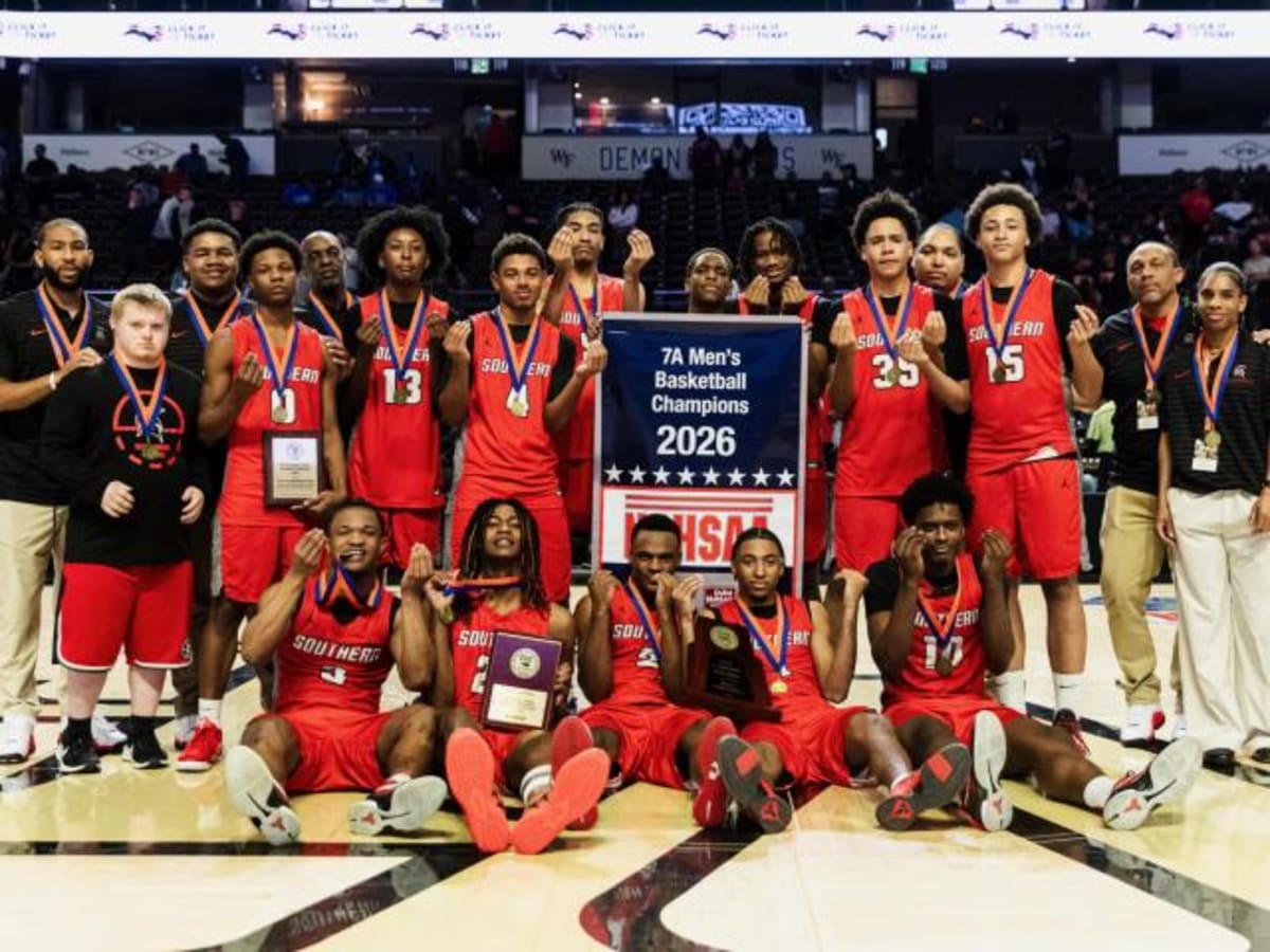 Southern Durham Spartans basketball team celebrating their first state championship with trophy